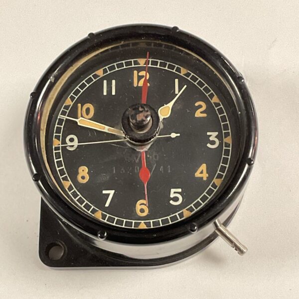 Vintage WW2 aircraft clock with black dial and white numerals.
