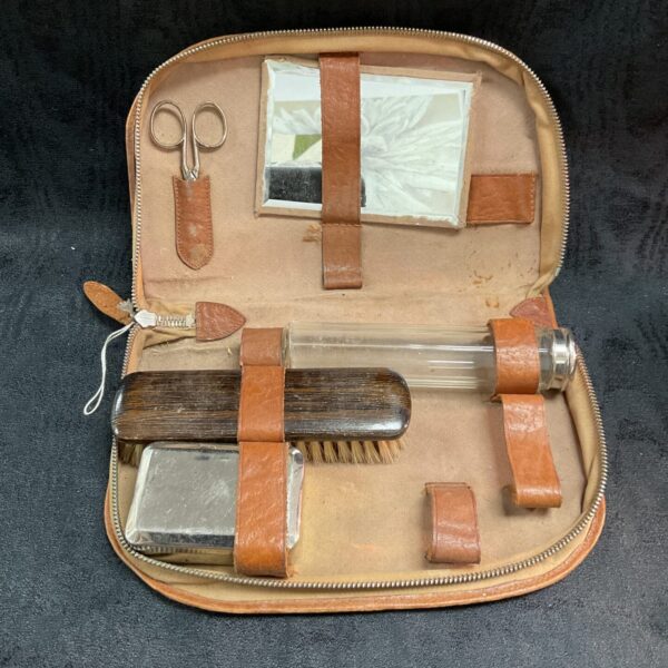 Open WW2 German shaving kit showing vintage grooming tools inside leather pouch.
