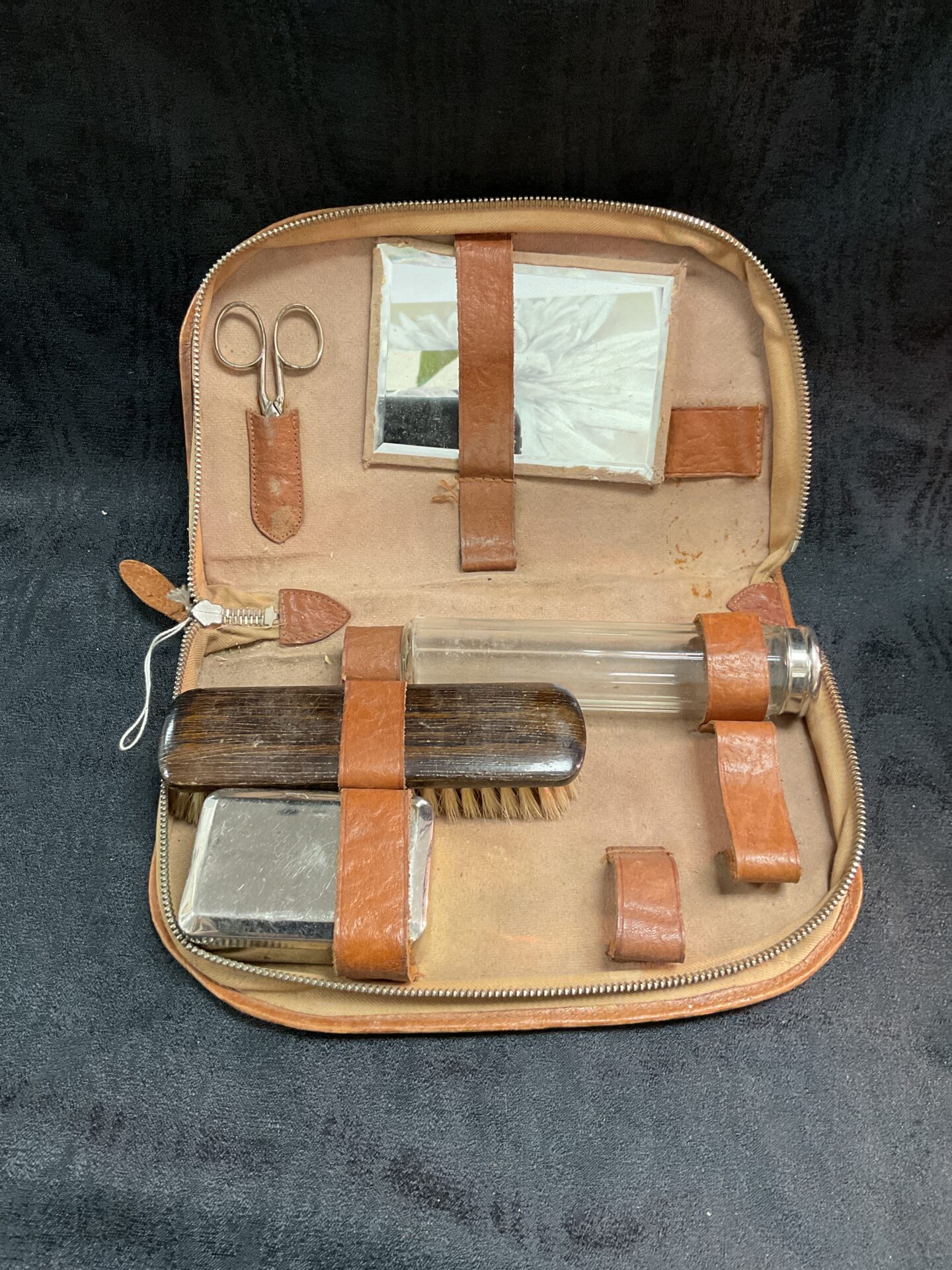 Open WW2 German shaving kit showing vintage grooming tools inside leather pouch.