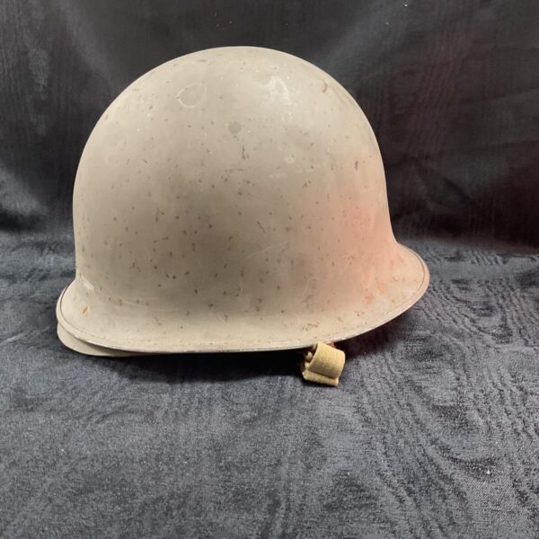 Vintage WWII US Army helmet with khaki liner.