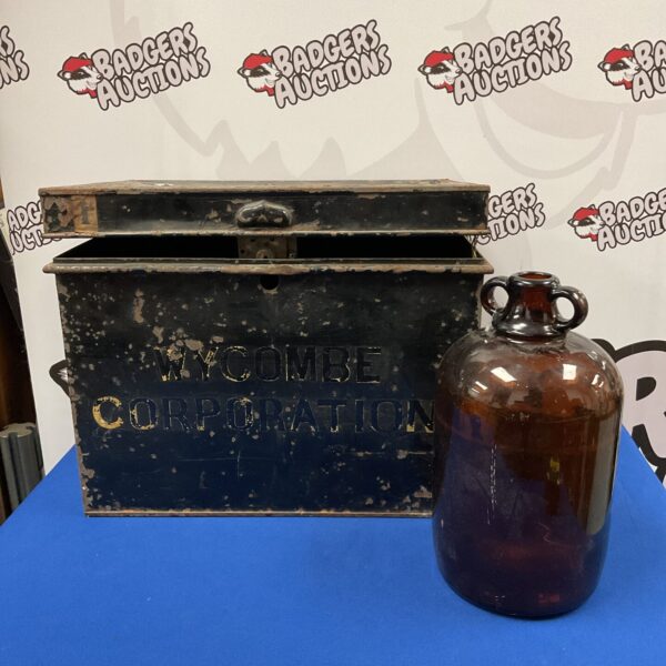 Antique Wycombe Corporation tin chest and brown glass demijohn.