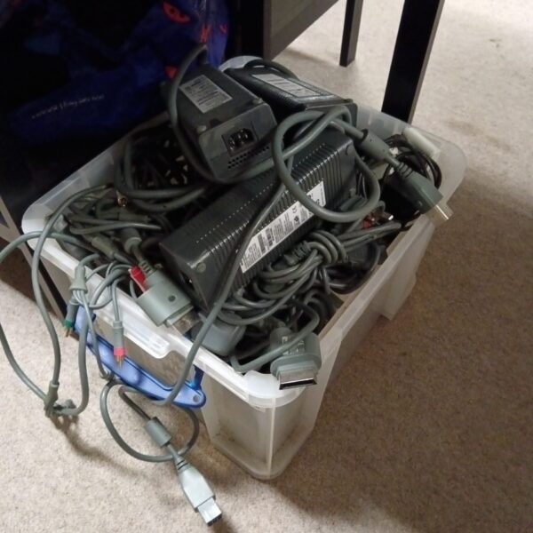 Lot of Xbox 360 power supplies for gaming console repair.