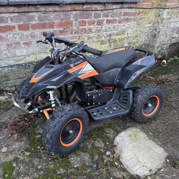 Side view of the XTM Dirt Monster electric quad bike.