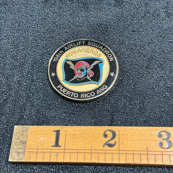 Front of 198th Airlift Squadron challenge coin with pirate design.
