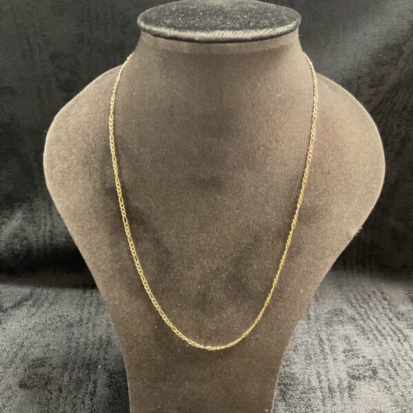 Elegant 9 carat gold Figaro necklace on a display stand.