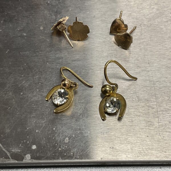Close-up of a pair of 9 carat gold stud earrings.
