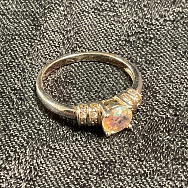 Silver ring with multifaceted crystal and white stones, size P.