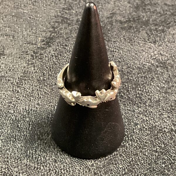 Close-up of a 925 silver fish ring on a display stand.