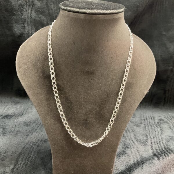 Delicate 925 silver chain necklace on a display stand.