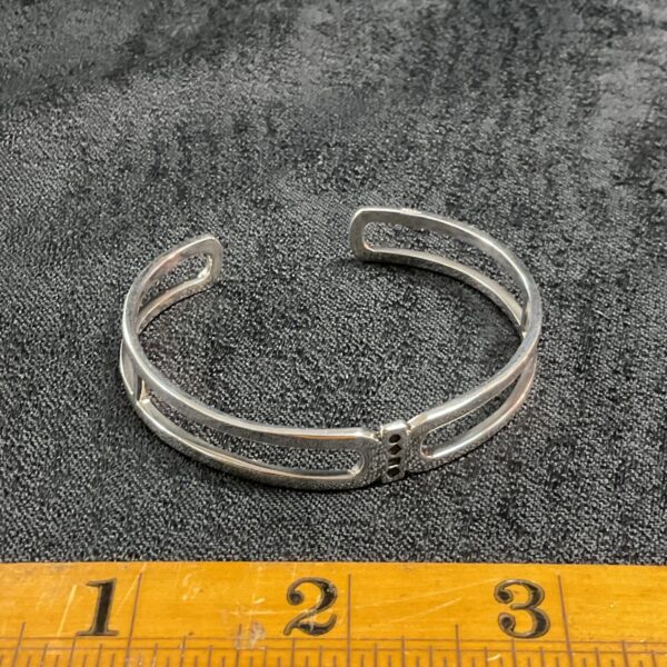 Close-up of 925 silver open frame bracelet, showcasing its minimalist design.