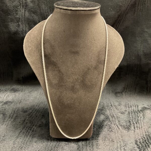 Close-up of a 925 silver rope chain necklace on a display stand.