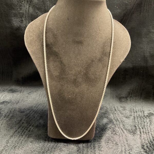 Close-up of a 925 silver rope chain necklace on a display stand.