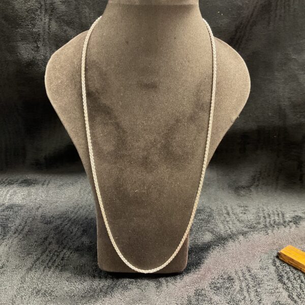 Close-up of a 925 silver rope chain necklace on a display stand.