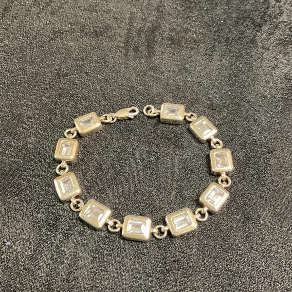 Silver square link bracelet with white stones.