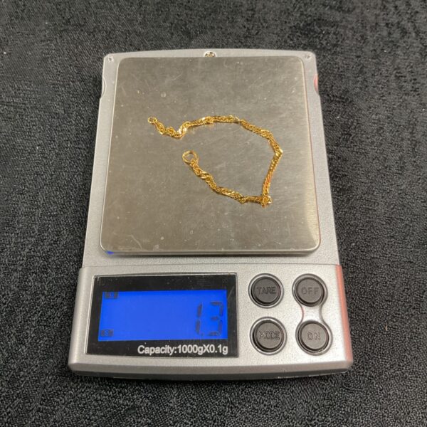 Close-up of 1.3g 9ct gold scrap chain for melting.