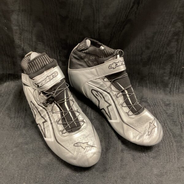 Silver Alpinestars race boots, a pair, motorsport footwear.