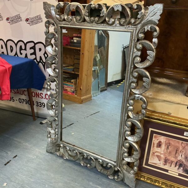 Ornate antique Baroque mirror with a gilded frame.