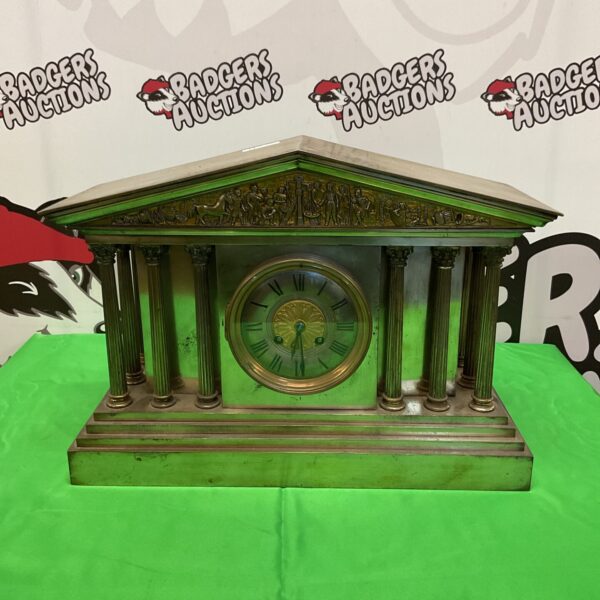 Ornate antique brass temple mantle clock with Roman numerals.