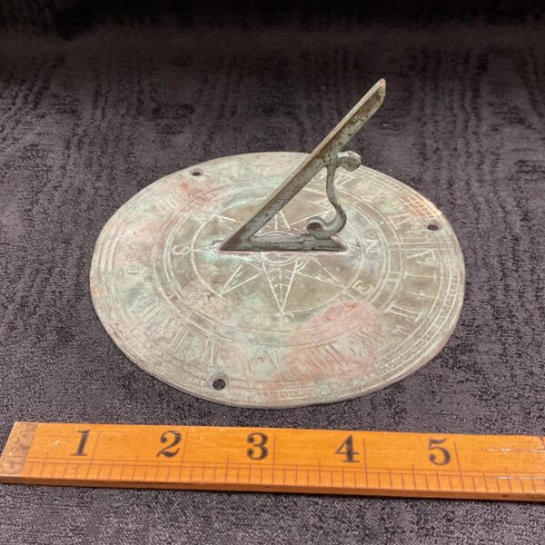 Antique bronze sundial from 1690, a vintage garden instrument.