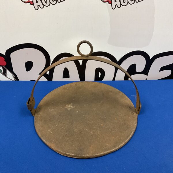 Antique cast iron hanging griddle with central loop.