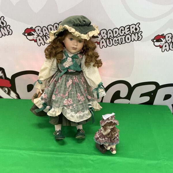 Antique collectable doll in Victorian dress with figurine.