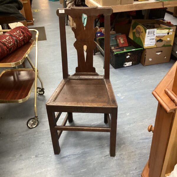 Antique English oak chair dating back to 1683, showing wear and character.
