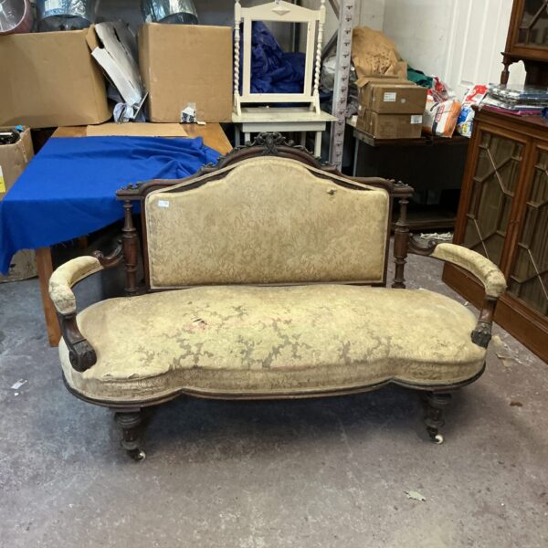 Antique French drawing room sofa needing restoration.