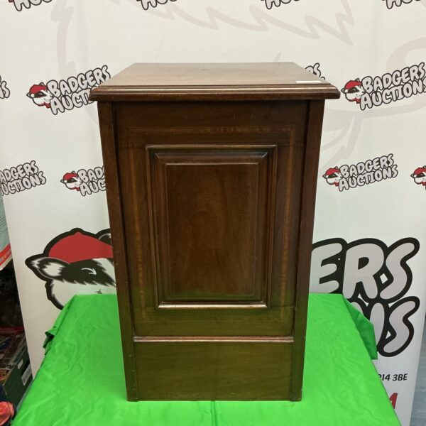 Front view of antique mahogany coal box with hinged door.