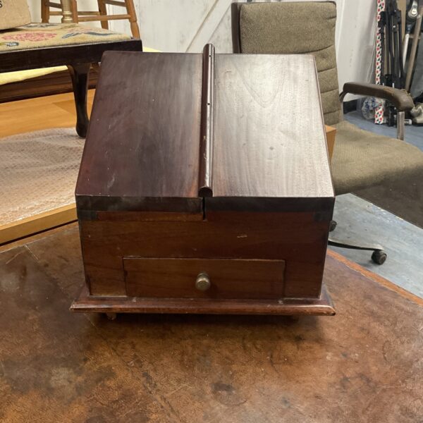 Antique mahogany stationary box with drawer and hinged lid.