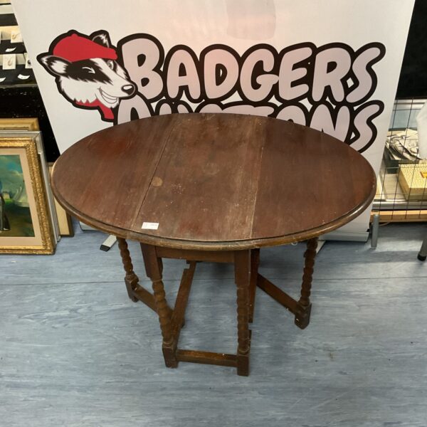 Antique oak barley twist gate leg table with oval top.