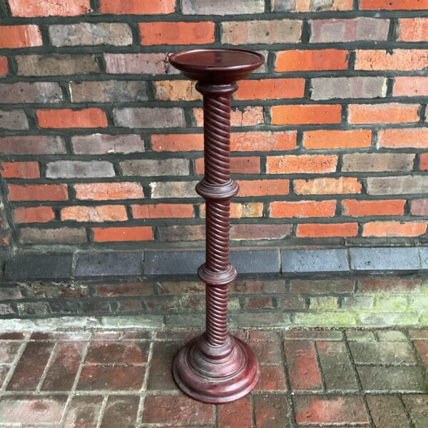 Antique oak jardiniere stand with turned column for displaying plants.