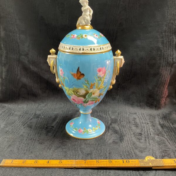 Antique porcelain potpourri vase with floral and butterfly decor.