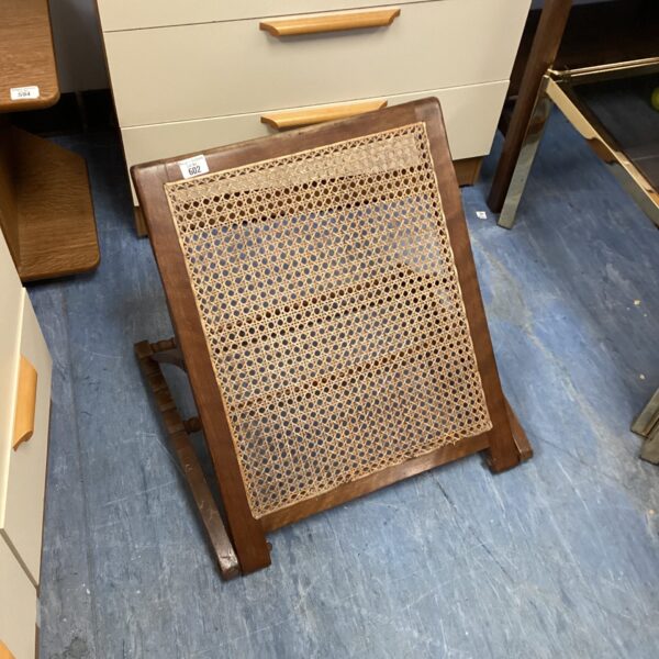 Antique rattan adjustable bedrest with woven panel and wooden frame.