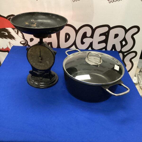 Antique Salter scales and a large casserole pot on display.