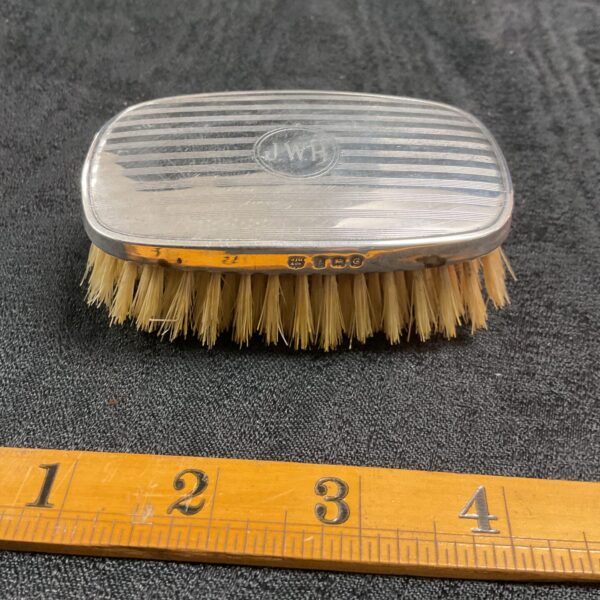 Antique sterling silver clothes brush with hallmarked silver handle.