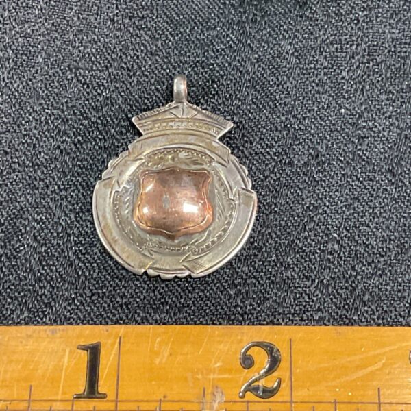 Antique silver fob with a gilded shield cartouche.