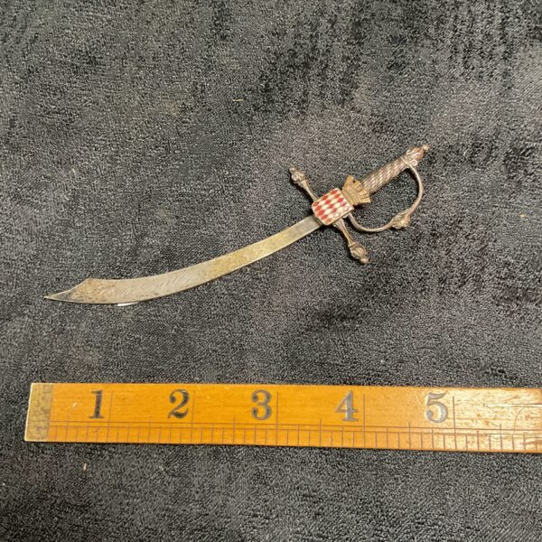 Antique silver plate paper knife with detailed handle.