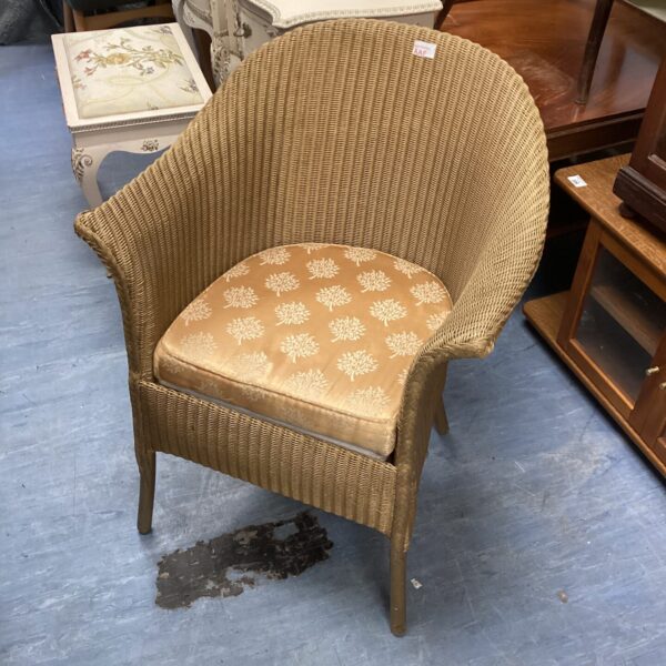 Antique wicker commode chair with woven seat and back.