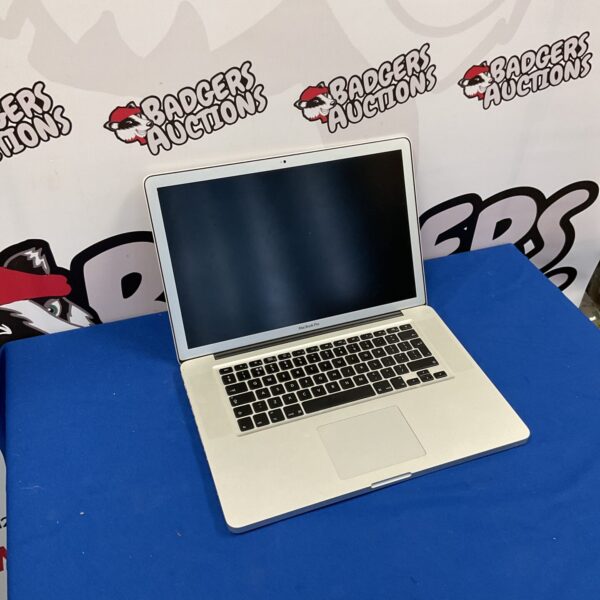 Vintage Apple Macbook Pro laptop, model 1286, showing wear.