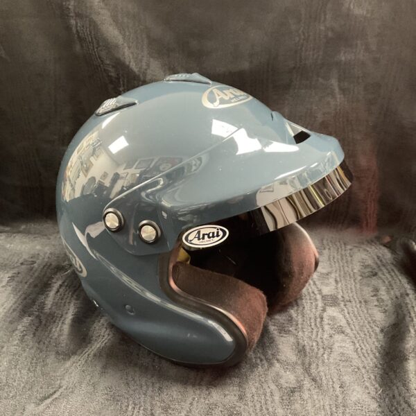 Vintage blue Arai race helmet, front view.