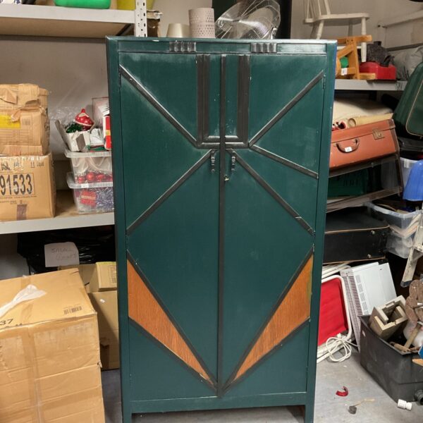 Front view of a green Art Deco wardrobe with geometric details.