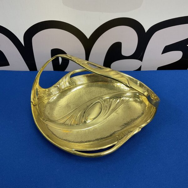 Antique Art Nouveau brass dish with elegant curved handle.