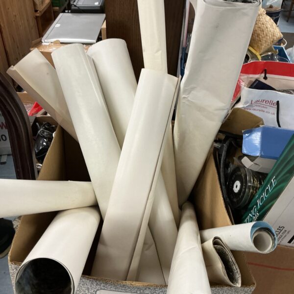Rolled art posters in a box, vintage graphic prints.