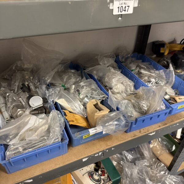 Assorted nuts, bolts, and screws in four trays, hardware lot.