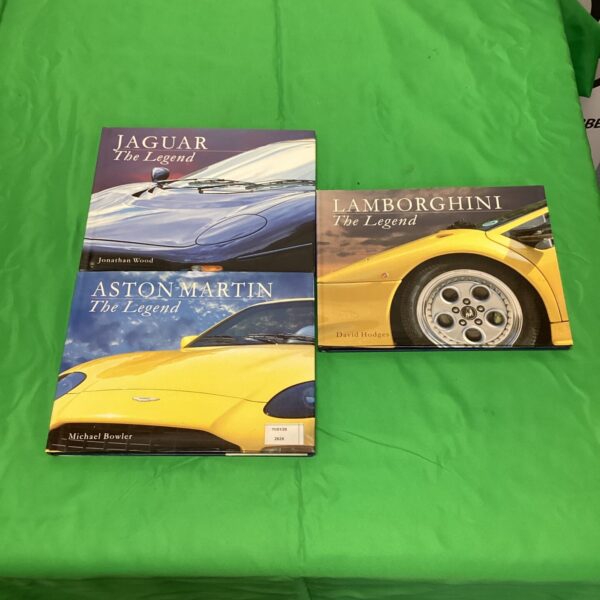 Supercar books lot featuring Aston Martin, Jaguar, and Lamborghini titles.
