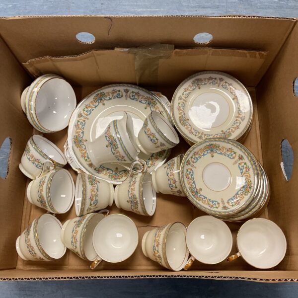 Vintage Aynsley china teacups and saucers with a floral pattern.