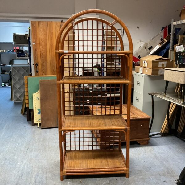 Rustic bamboo shelving unit with curved top and multiple tiers.