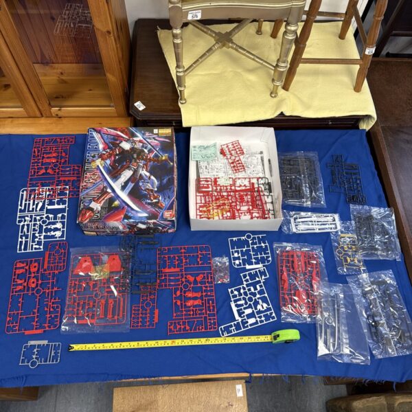 Bandai Gundam Astray Red Frame model kit, incomplete plastic parts.