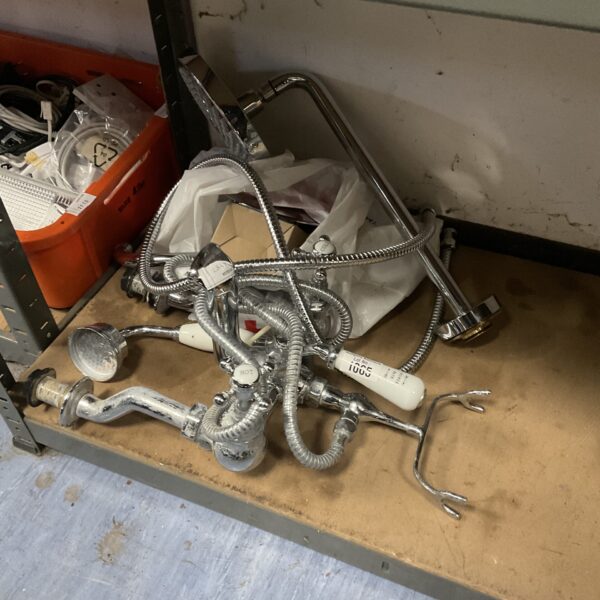 Used bath shower mixer tap set with limescale deposits.
