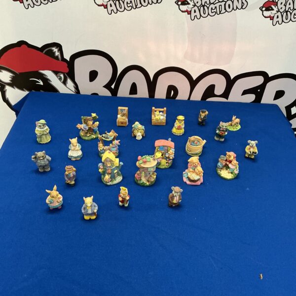 Collection of miniature porcelain bear figurines on display.